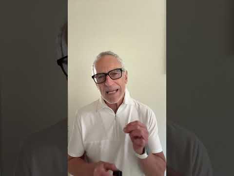 Elderly person performing a chair rise test in a bright physical therapy clinic, with a therapist observing knee movement and strength